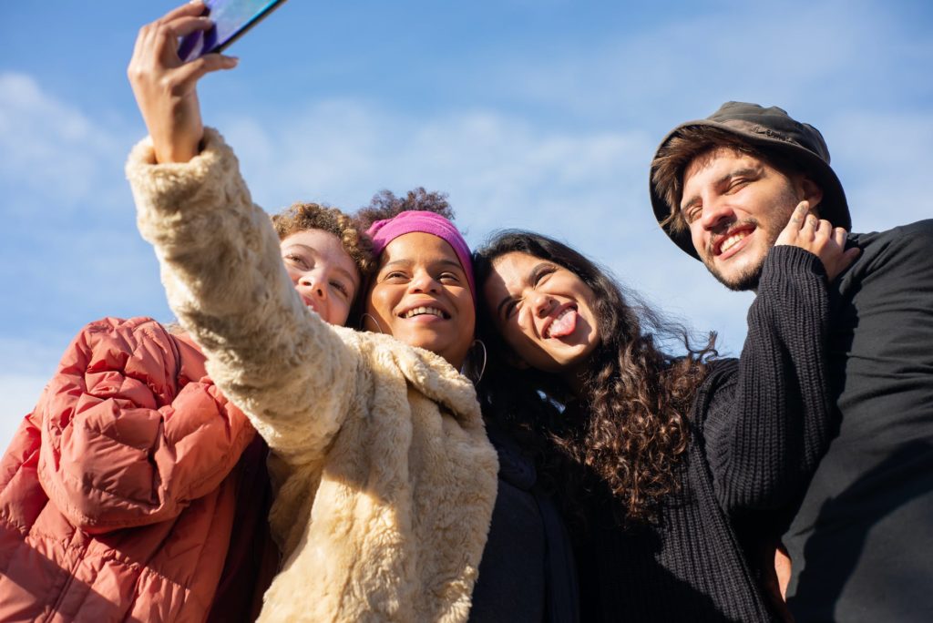 Friends posing with a camera; get therapy for your anxiety so you can enjoy moments like this.