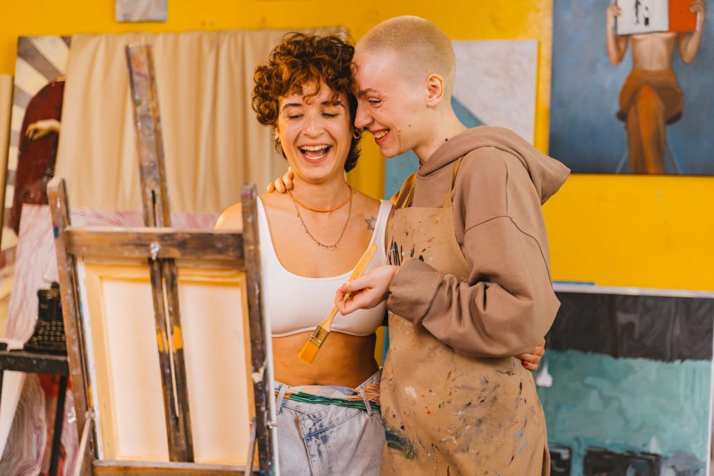 Two artists appreciating a painting they made. Learn how to cure art block based on its causes.