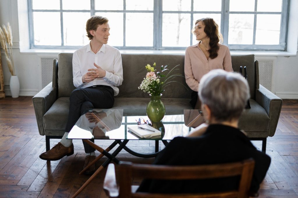 A couple on a couch discussing how long it takes therapy to work.