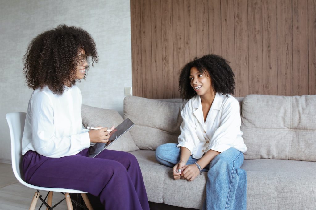 A woman seeing a female therapist for her first therapy session.