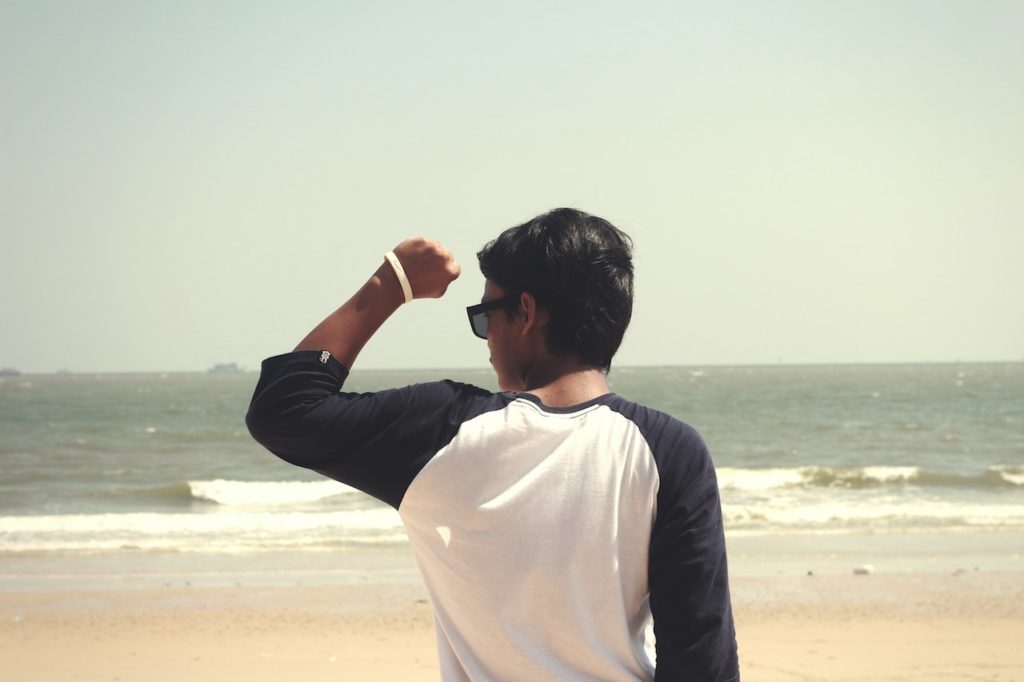 Man at seashore, ready to make a New Year's resolution.